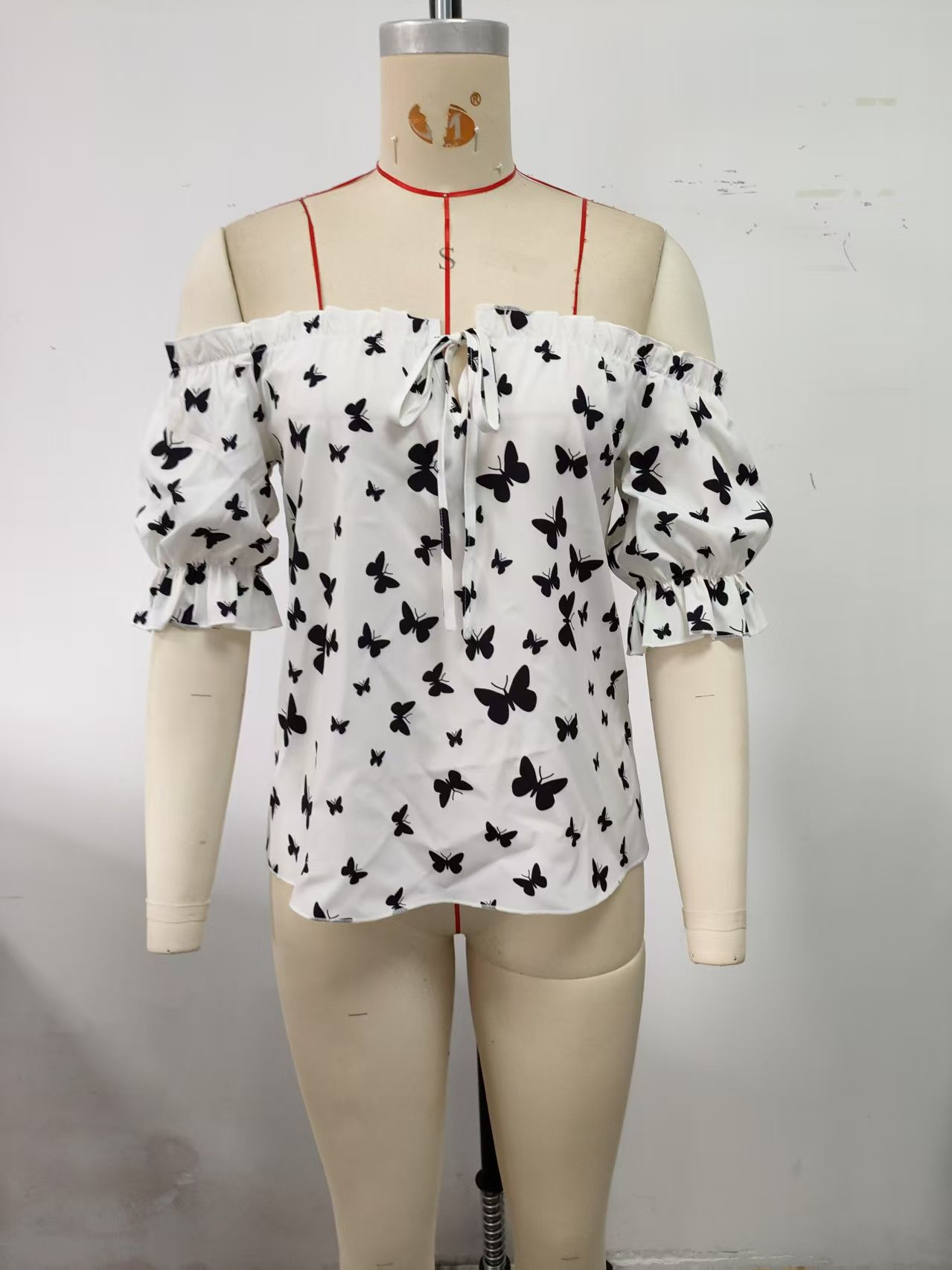 White, women's top, off shoulder, black butterfly print