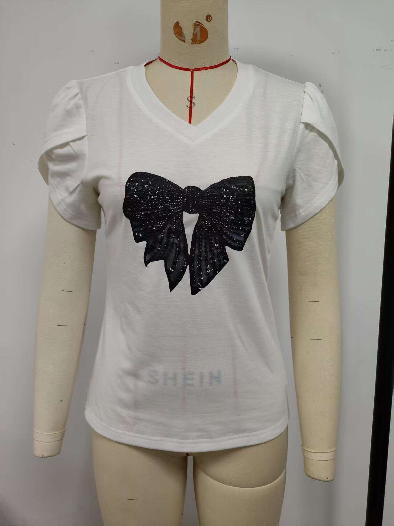 White, V-neck T-shirt with black bow decoration